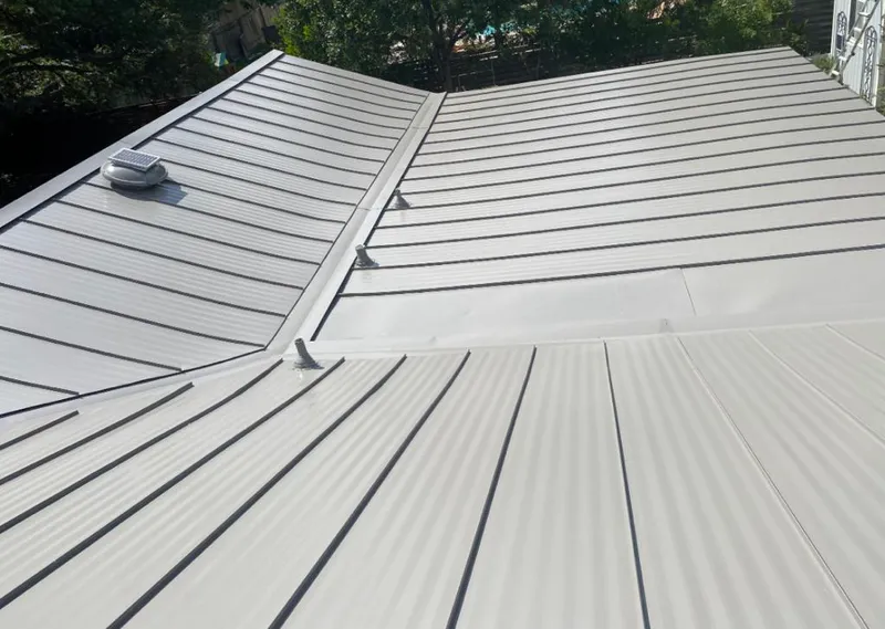 Solar attic fan installed on a metal roof for Roof Ventilation in Cottonwood Heights